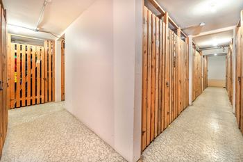 A long hallway with wooden walls and a cracked floor.